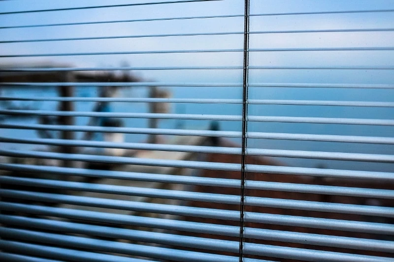 Open clean blinds with view of ocean