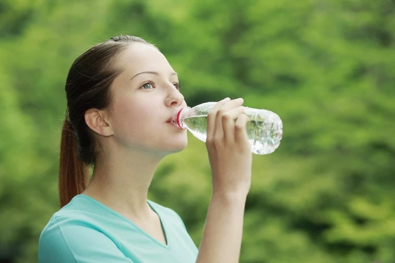 Woman drinking a bottle of water