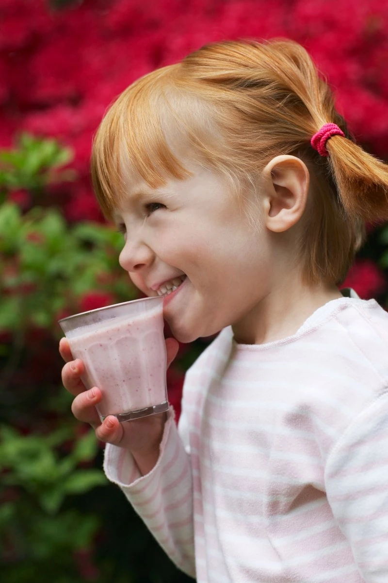 Little Girl Drinking A Smoothie