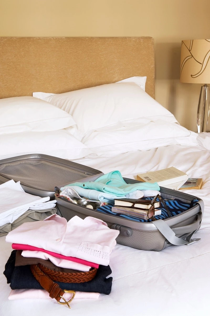 Suitcase sitting on bed