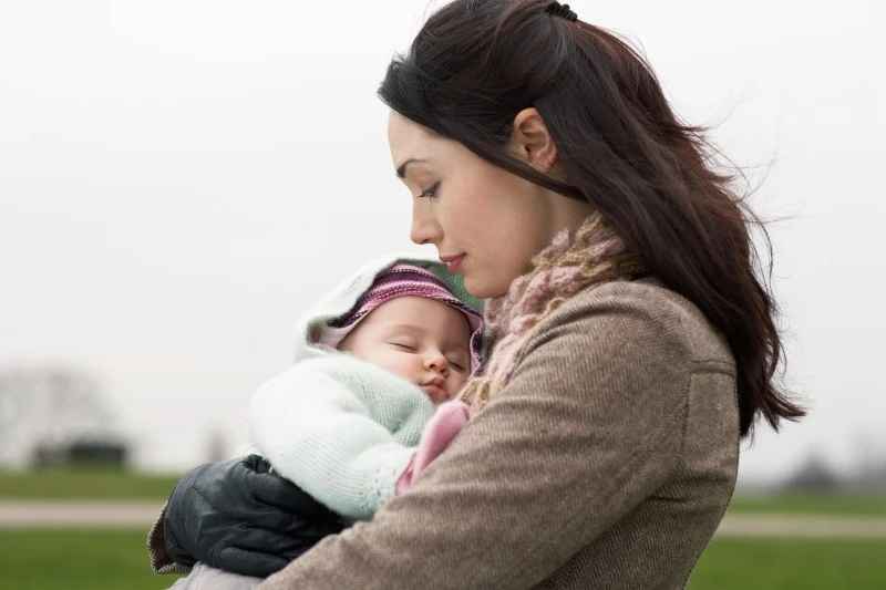 Mother Holding Sleeping Baby