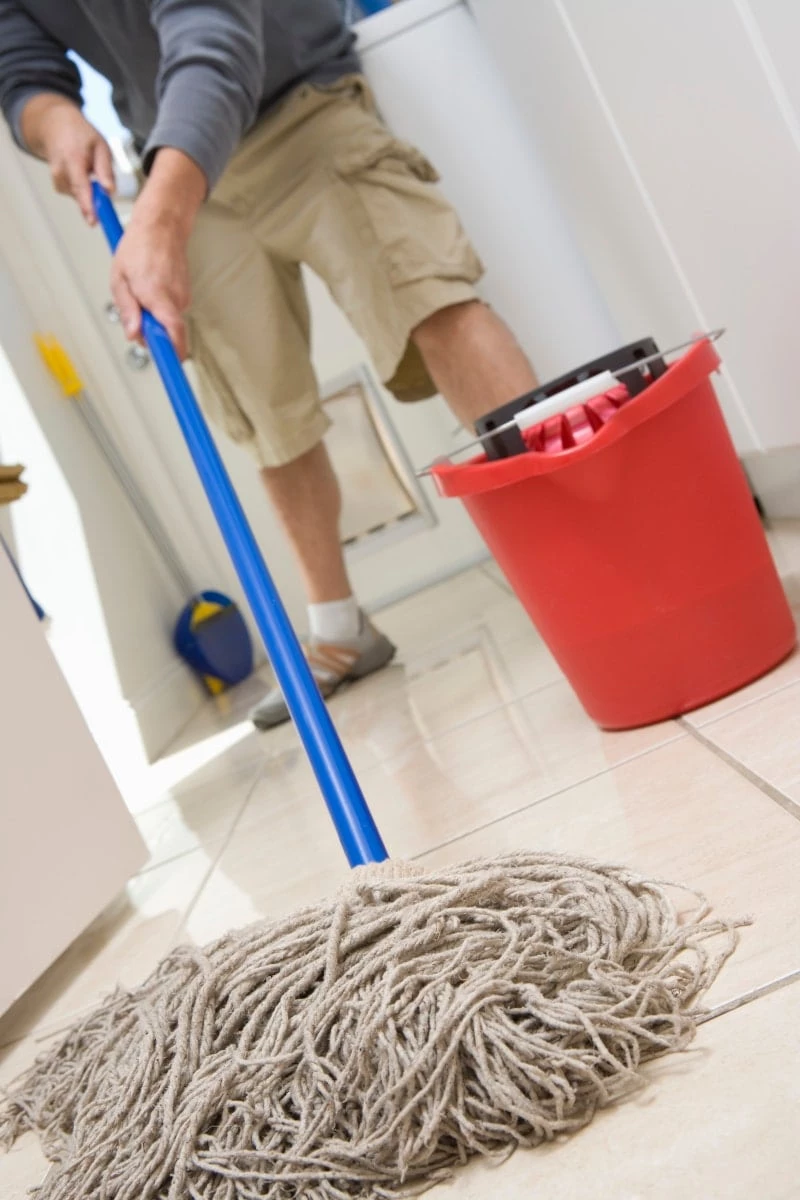 Husband mopping tile floors