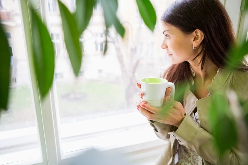 Mom Drinking Tea While Looking Out The Window