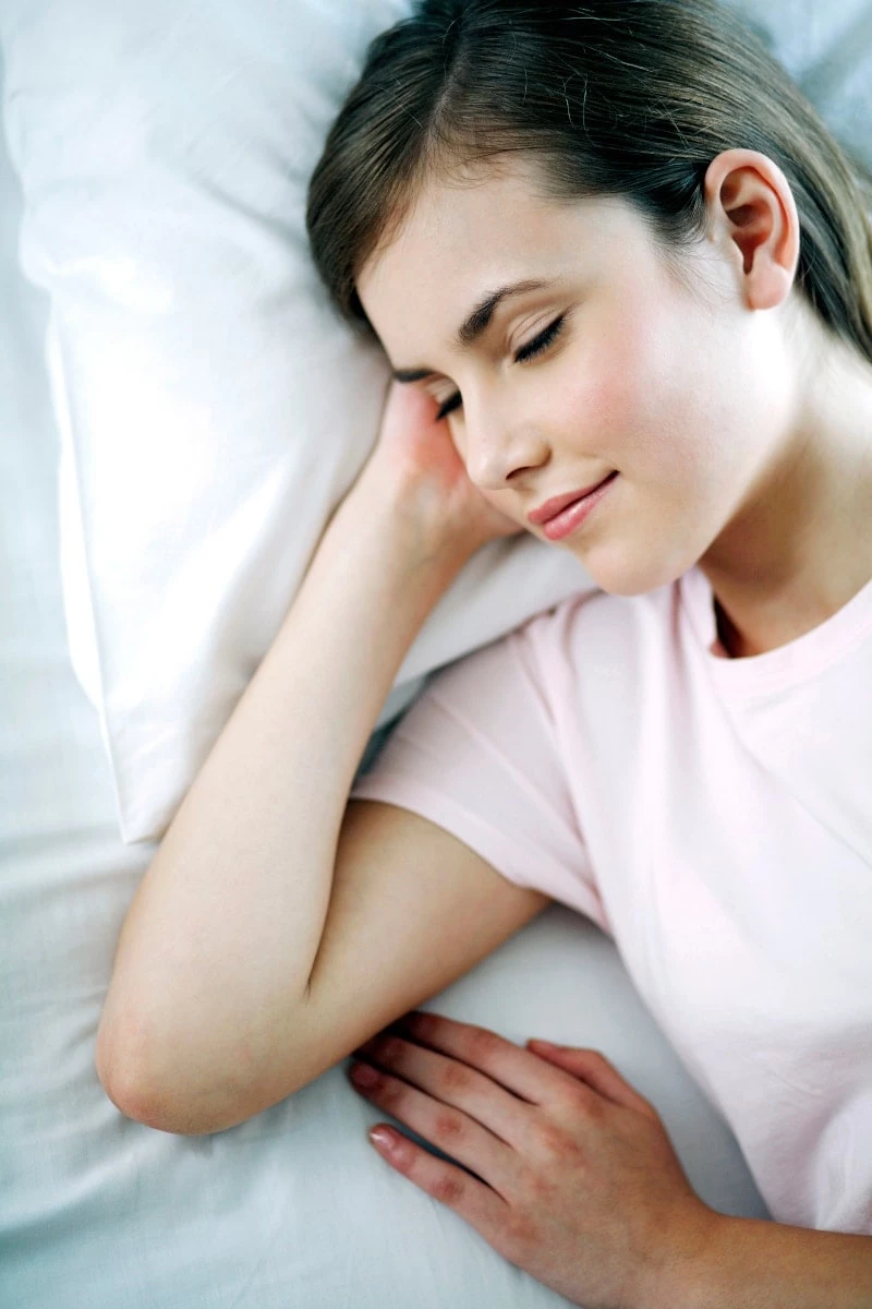 Mom laying in bed taking a nap