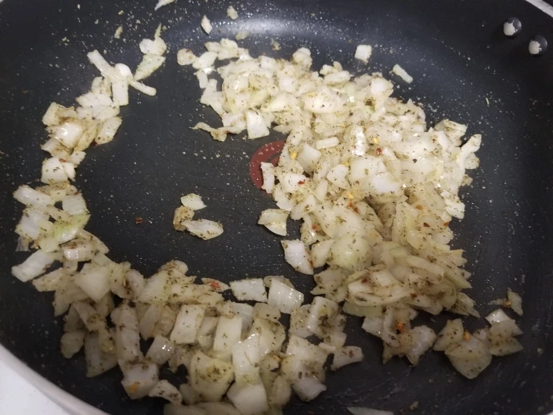 Onions with seasoning frying in a pan