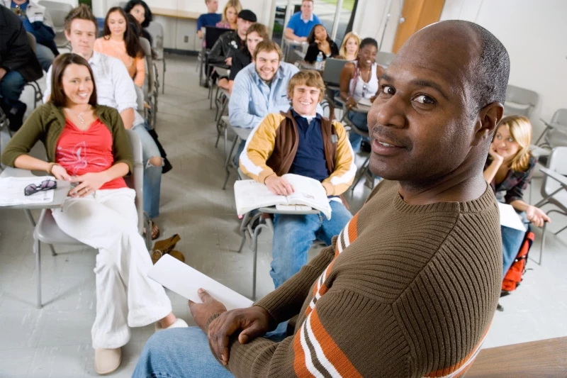 Black teacher in front of students teaching