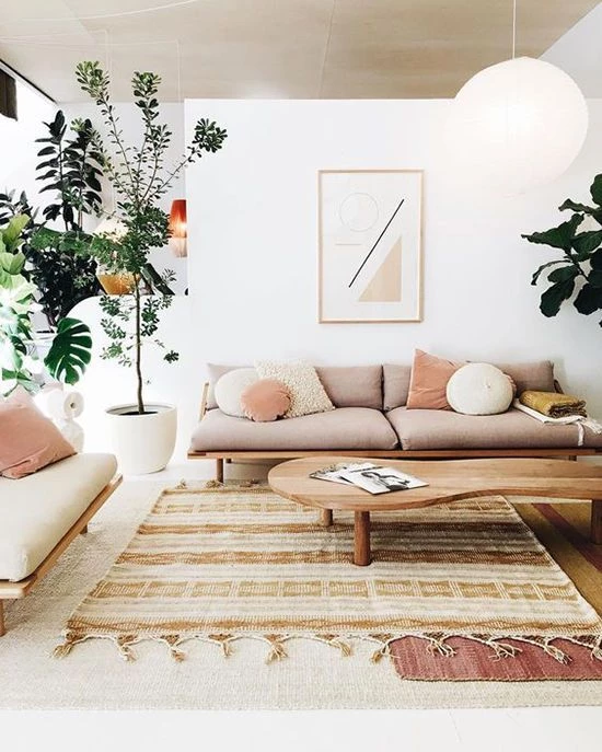 A Scandinavian style living room that uses lots of soft dusty pinks and earthy tones