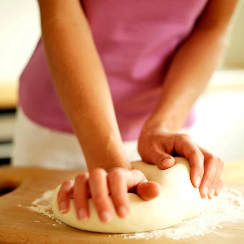 Woman kneading bread