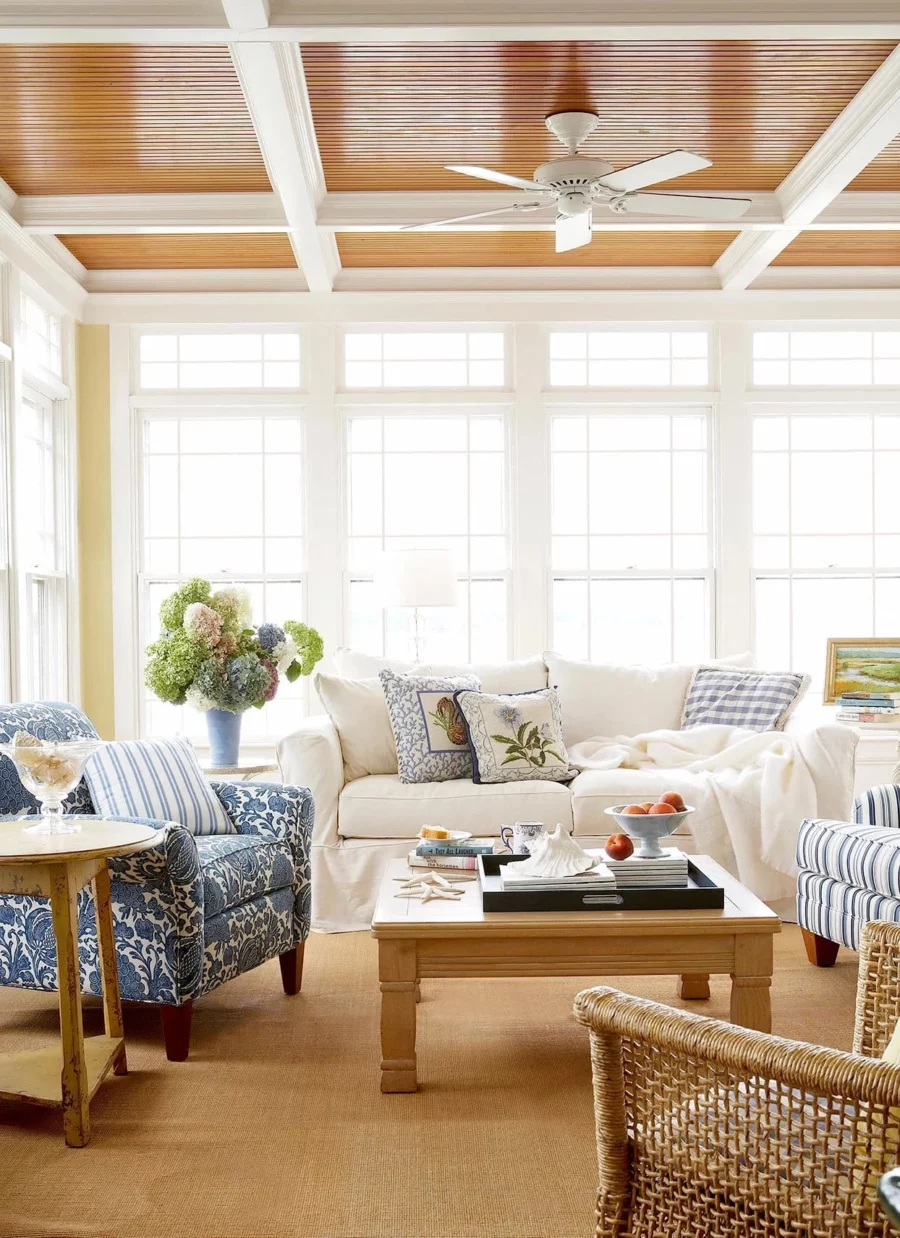 Living Room with a white sofa, blue chairs, and wicker accents