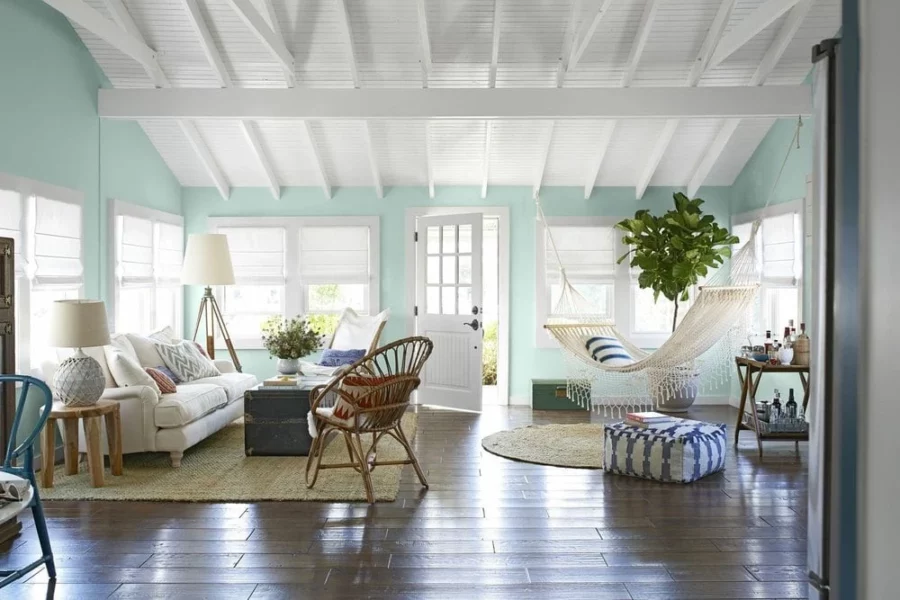 Aqua painted living room with a hammock and natural woven rugs