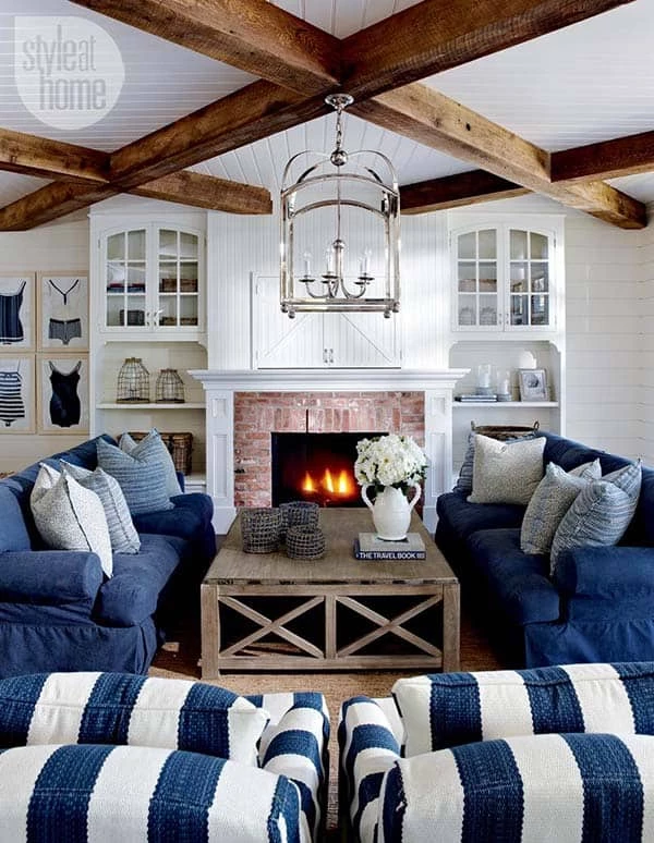 nantucket beach home living room with blue sofas and ship lap walls and ceiling