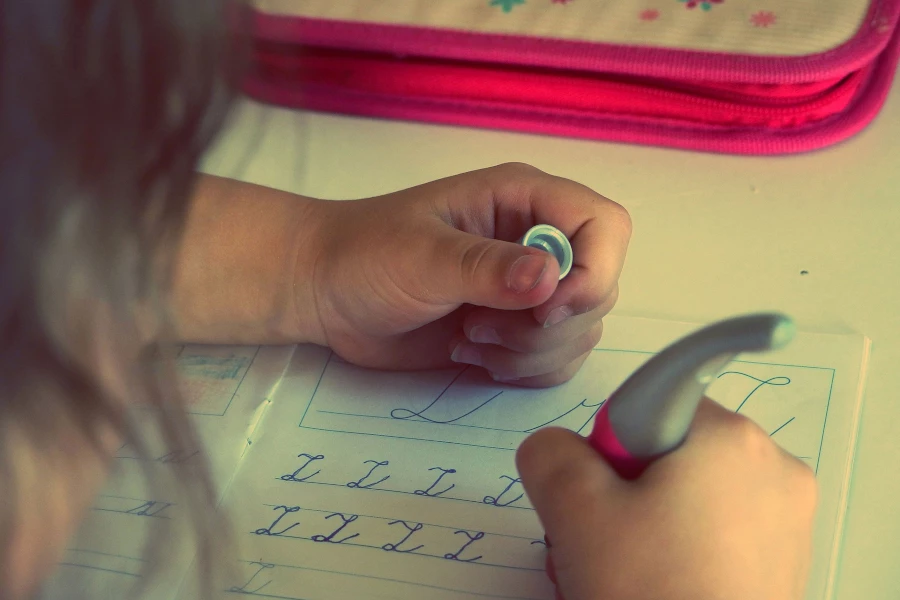 Child learning to write letters in cursive
