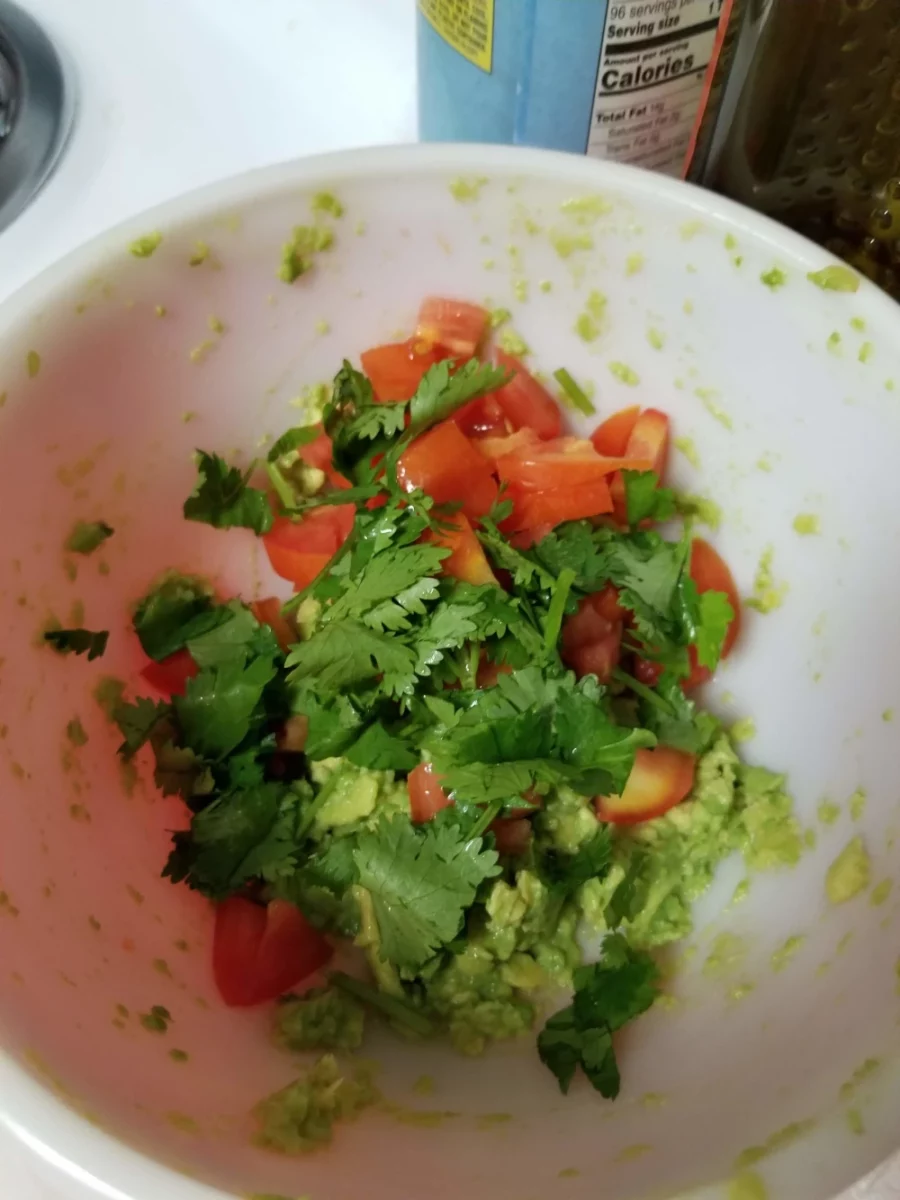 Fresh cilantro added to guacamole
