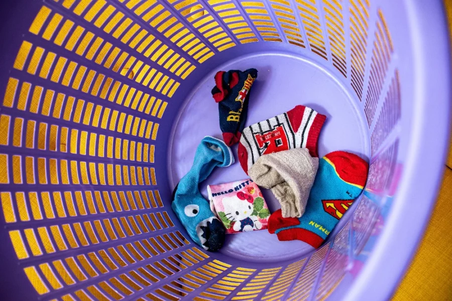 kids socks in a purple laundry basket