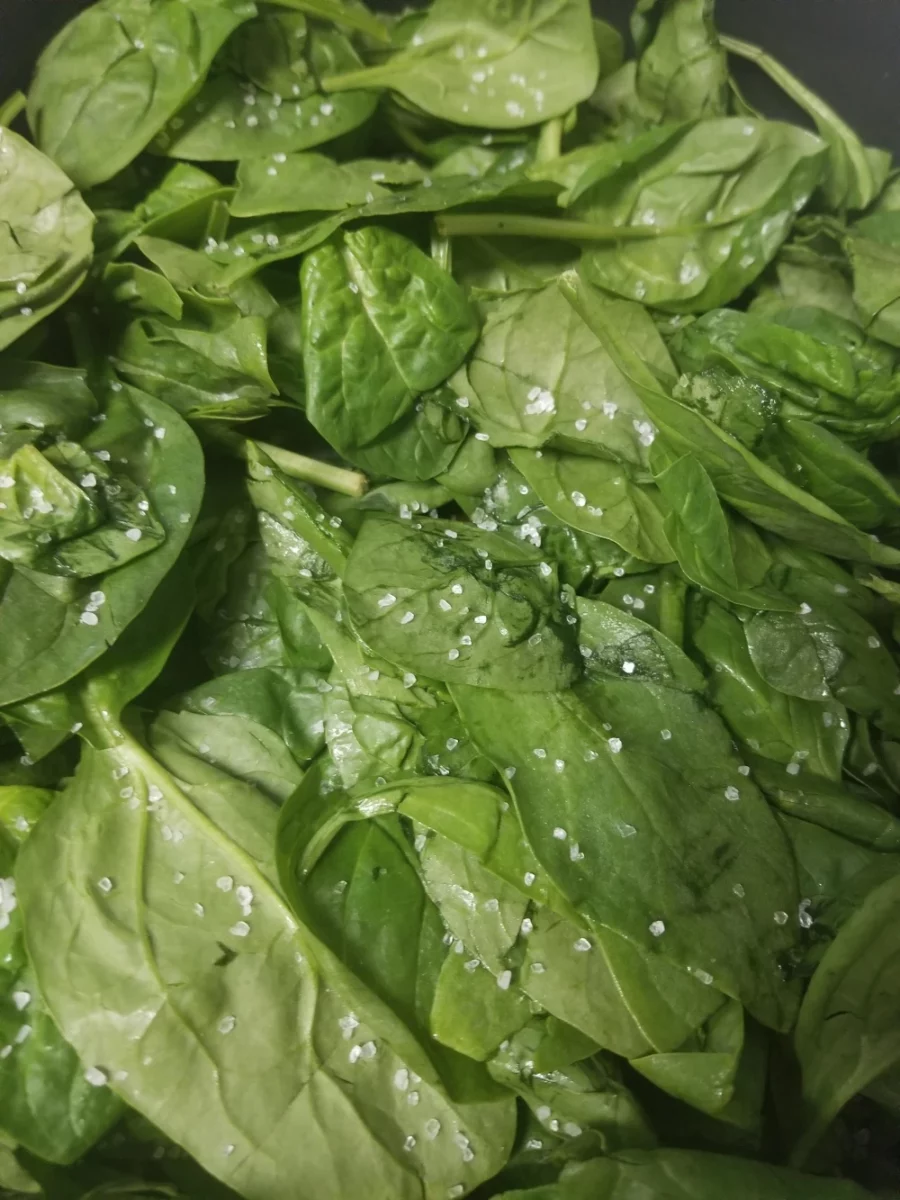 1 - Fresh spinach with flaky salt in a frying pan