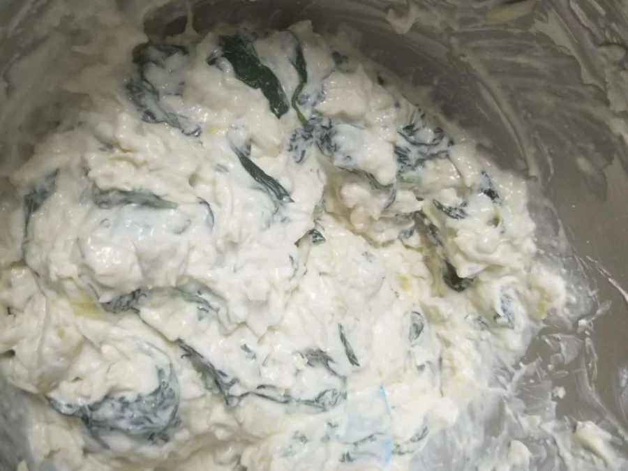 5 - Folding in spinach to cream cheese and artichoke mix