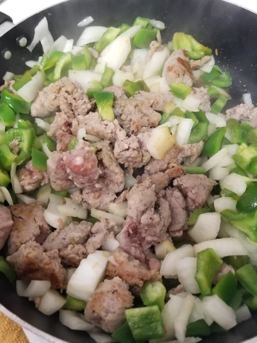 Italian Sausage, Green Pepper, and Onion Cooking in a skillet